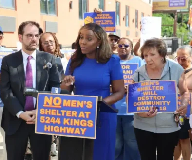 Council-Member-Farah-N.-Louis-flanked-by-Assemblymember-Kalman-Yeger-addresses-rally.-